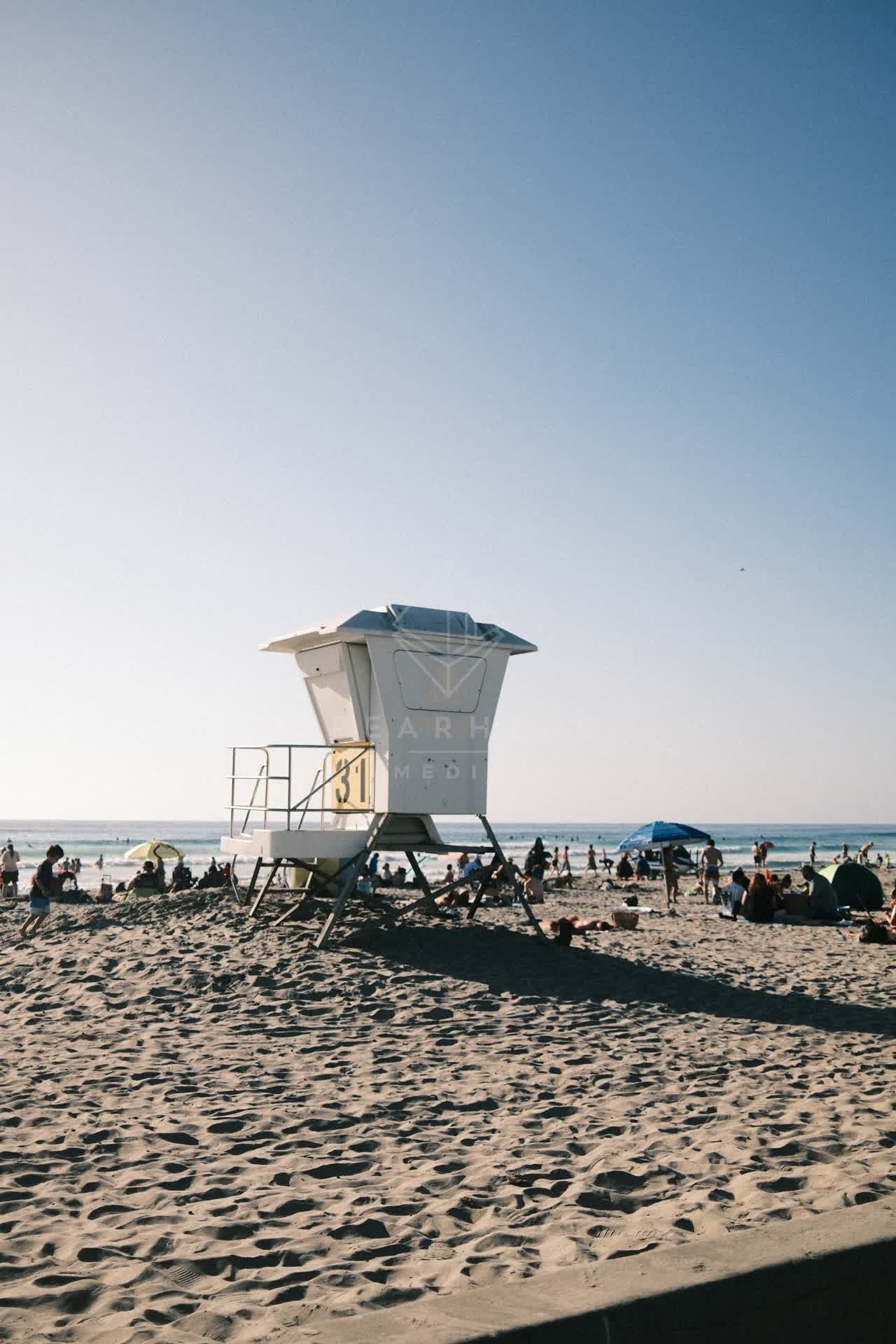 The beach, the ocean and open country at La Jolla Shores, with a crowd gathered.
