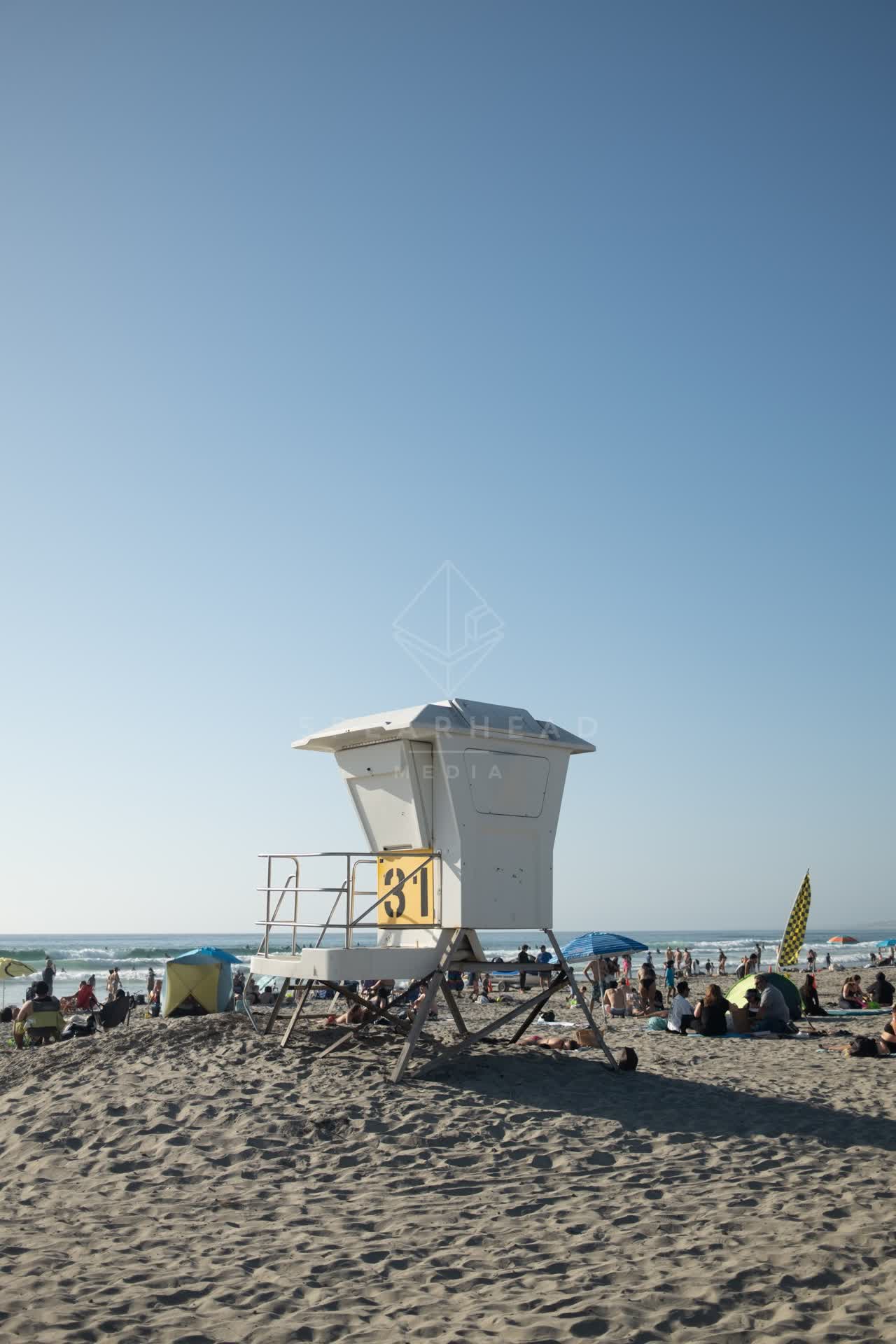 The beach, the surf and the ocean at La Jolla Shores, with a crowd gathered.