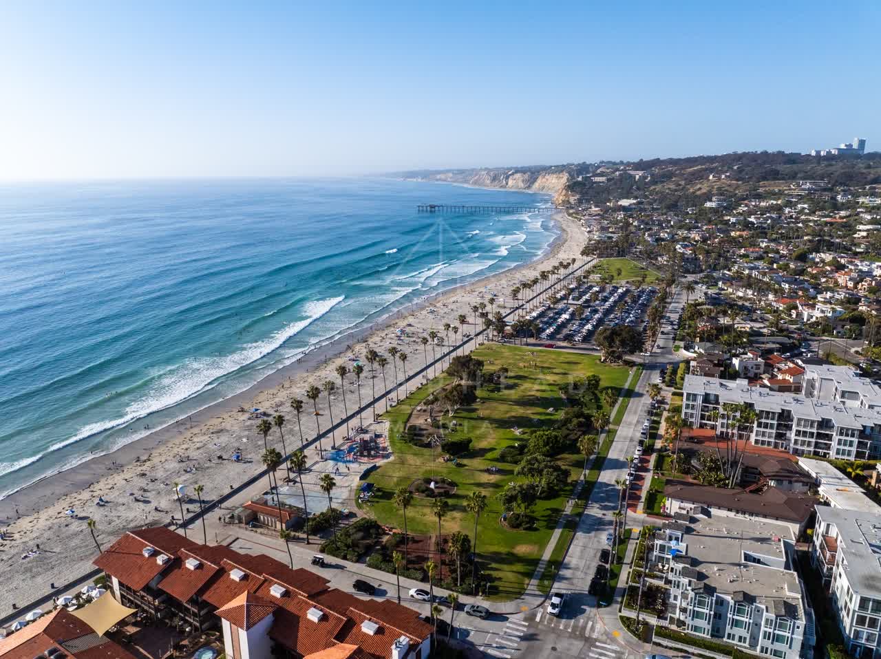 Aerial view of the beach, the surf and the pier at La Jolla Shores.