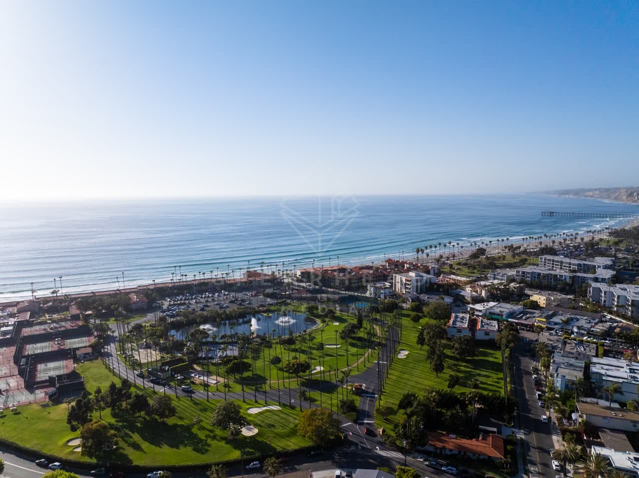 Aerial view of the beach, the pier and palm trees at La Jolla Shores.