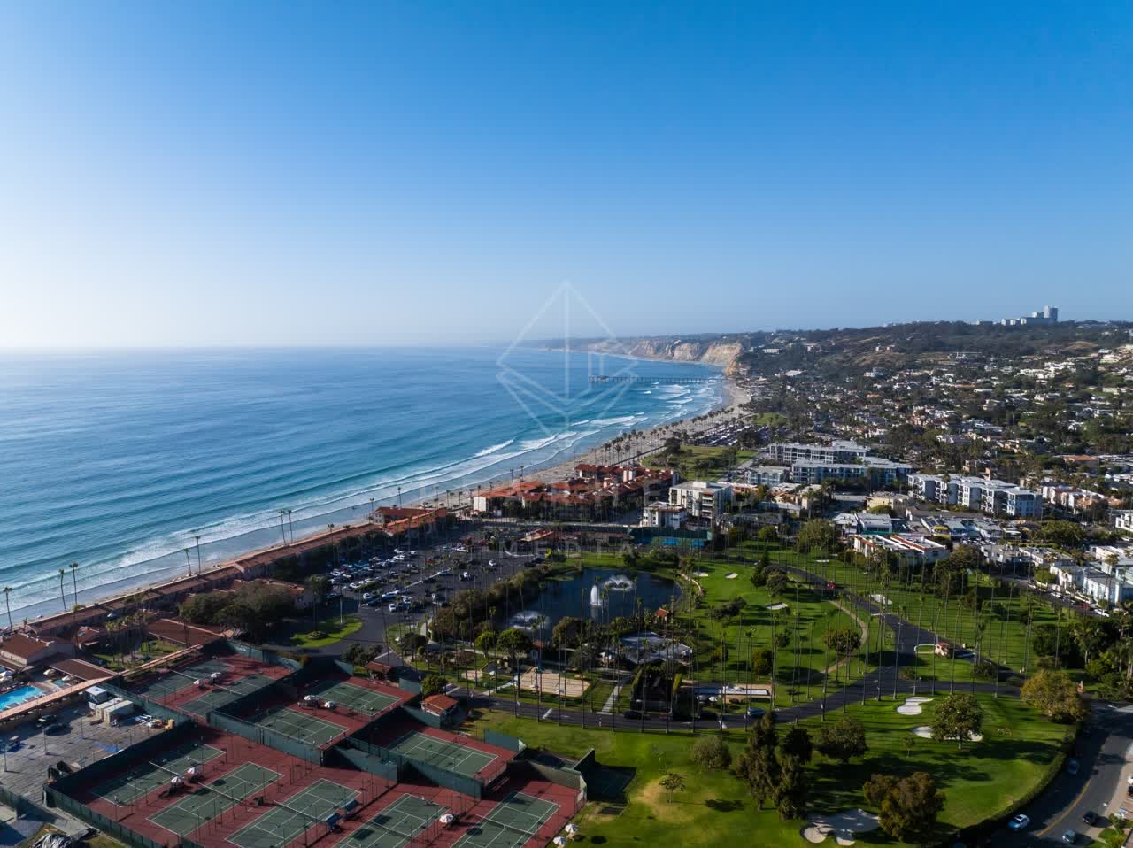 Aerial view of the beach, palm trees and the ocean at La Jolla Shores.