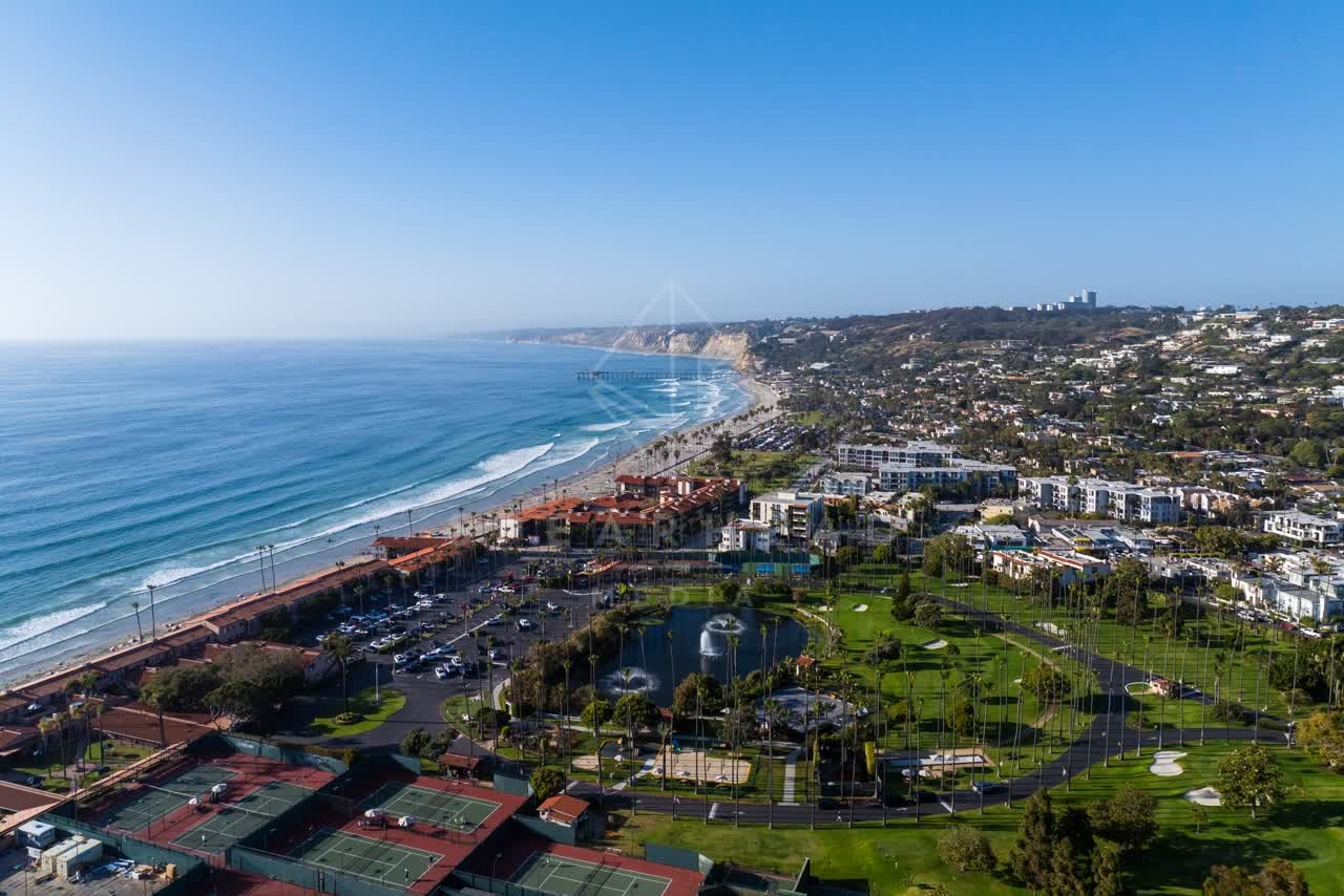 Aerial view of the beach, the surf and the pier at La Jolla Shores.