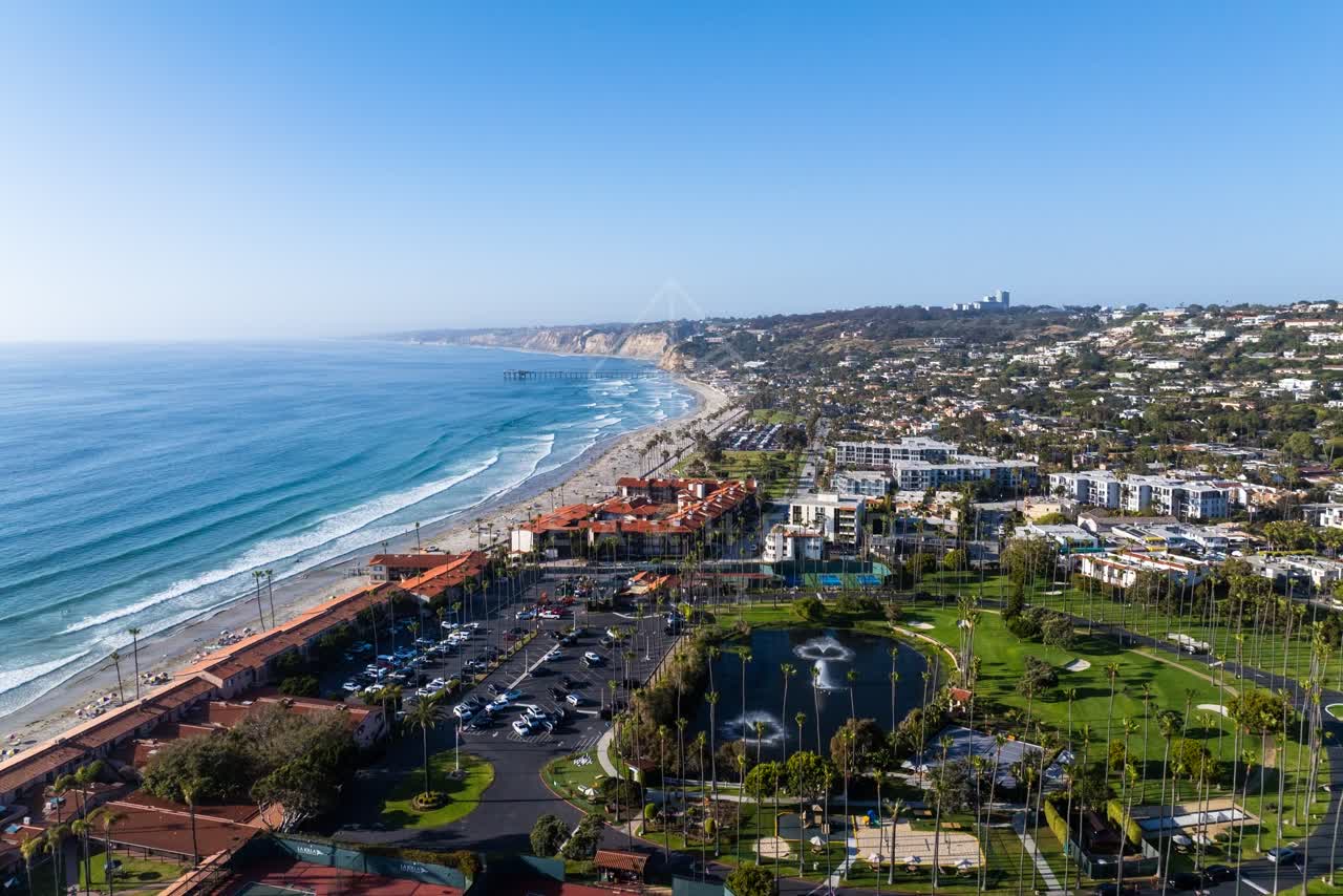 Aerial view of the beach, the surf and the pier at La Jolla Shores.