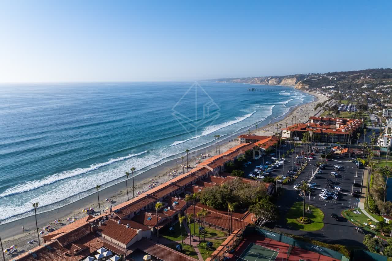 Aerial view of the beach, the pier and palm trees at La Jolla Shores.