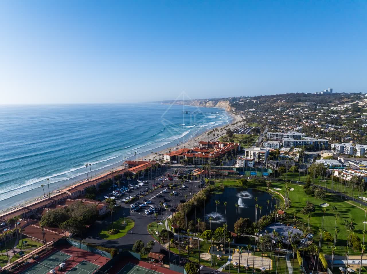 Aerial view of the beach, the surf and the pier at La Jolla Shores.