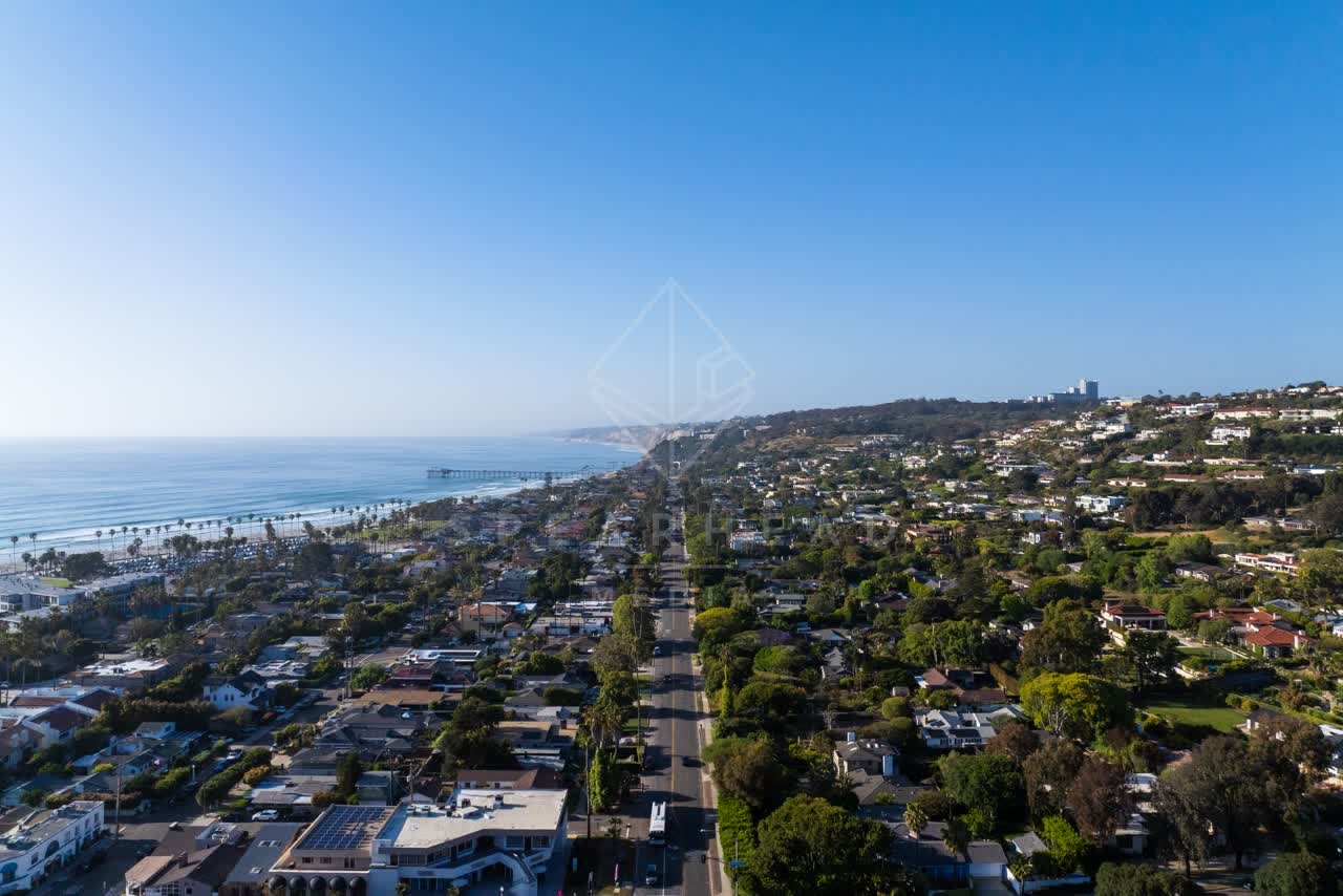 Aerial view of a residential street, the pier and the ocean at La Jolla Shores.