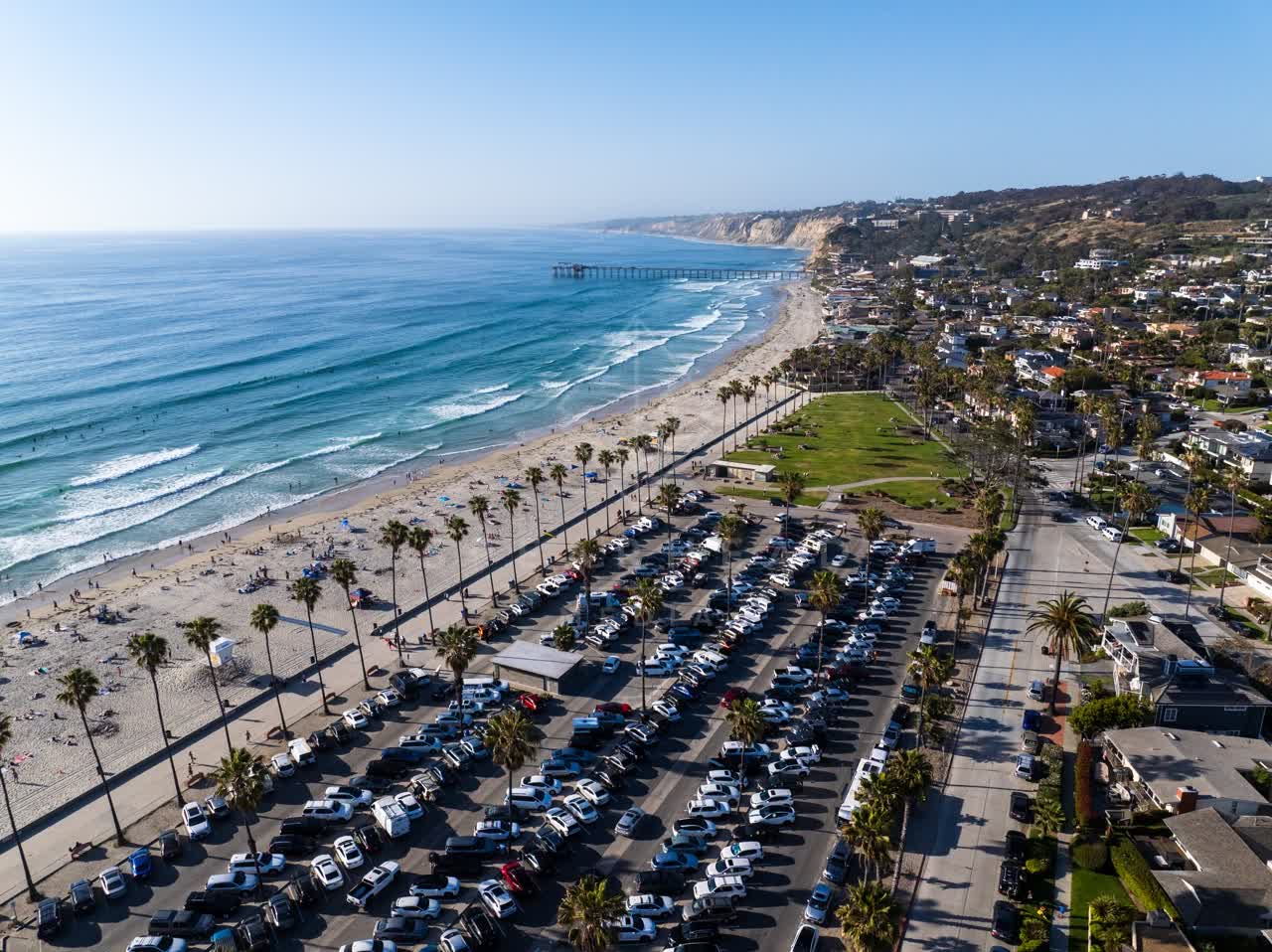 Aerial view of the beach, the surf and the pier at La Jolla Shores.