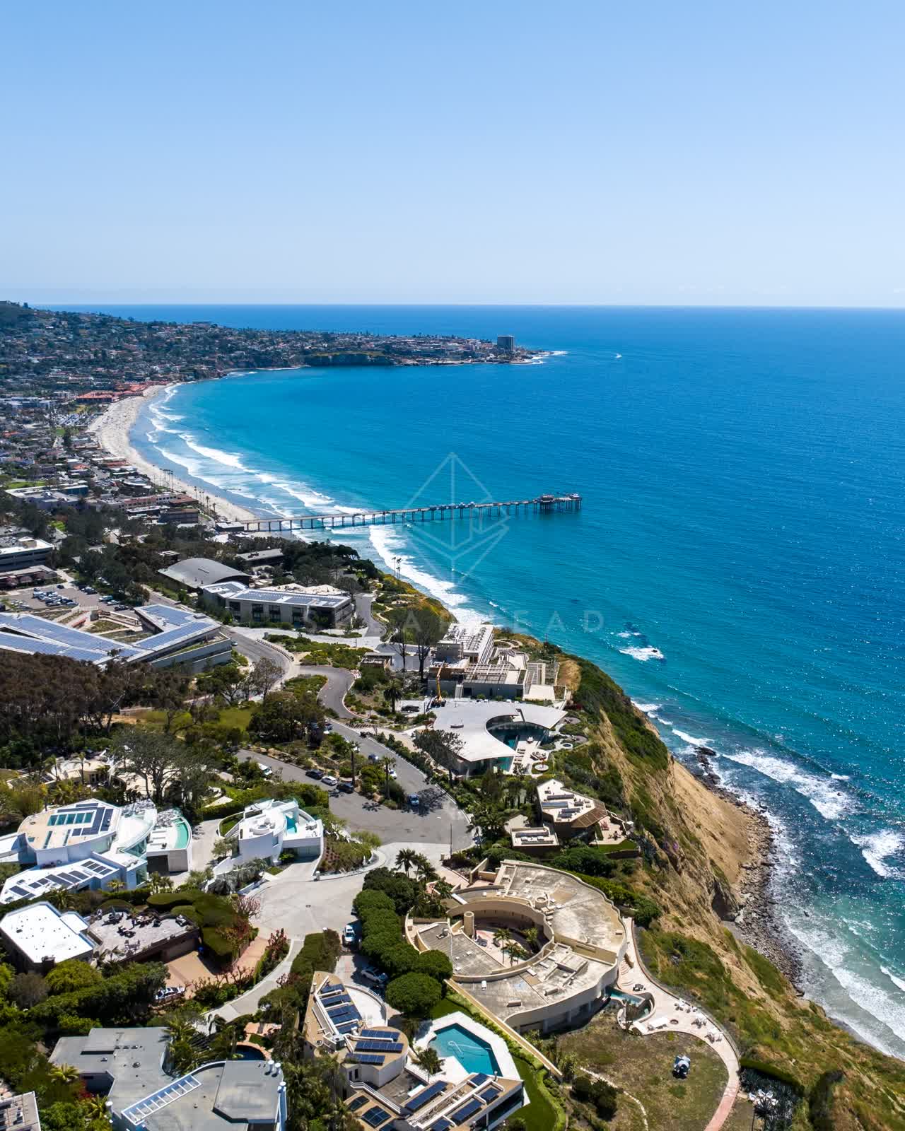 Aerial view of the cliffs, the surf and the pier at Black’s Beach.