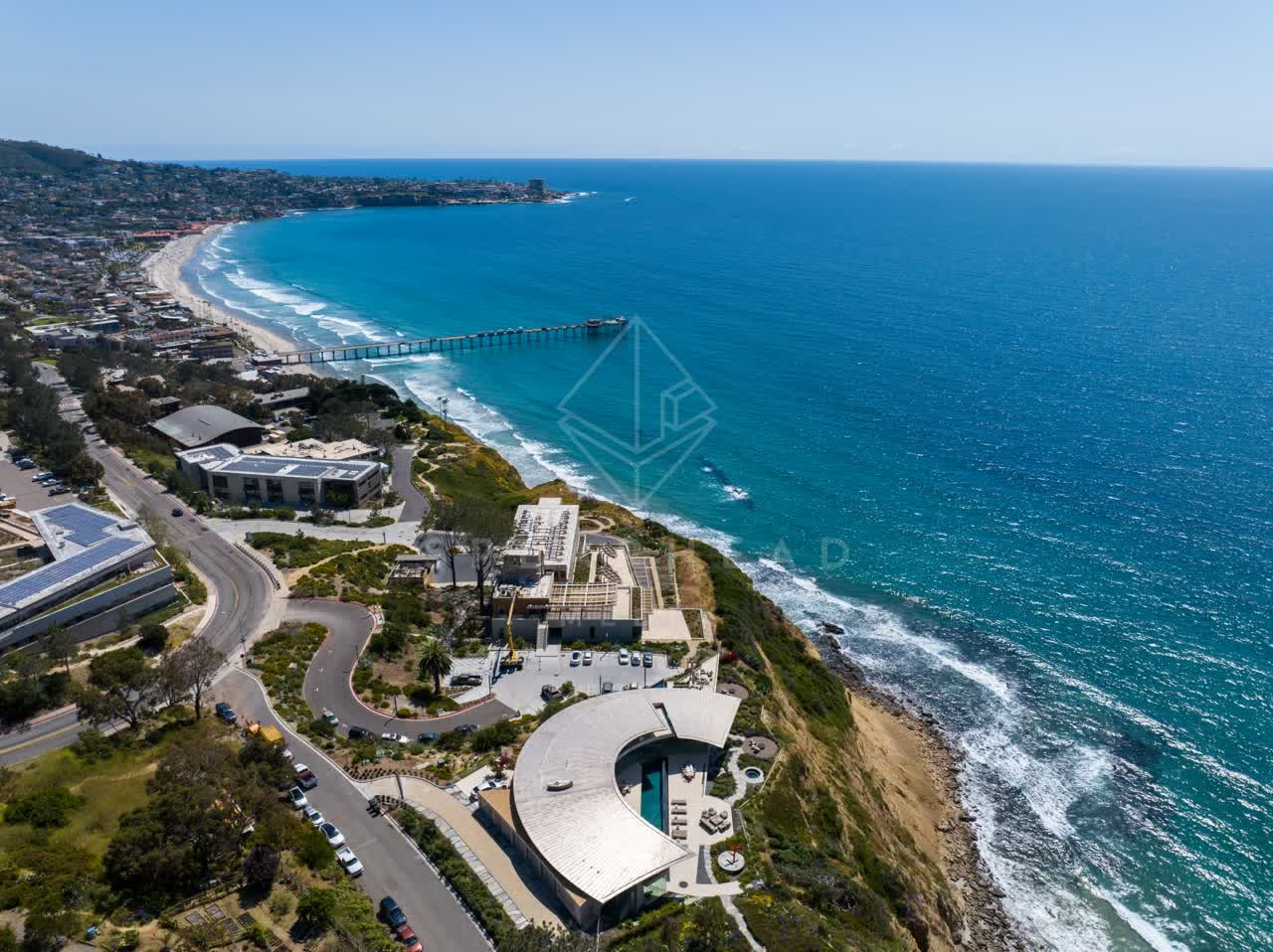 Aerial view of the cliffs, the surf and the pier at Black’s Beach.