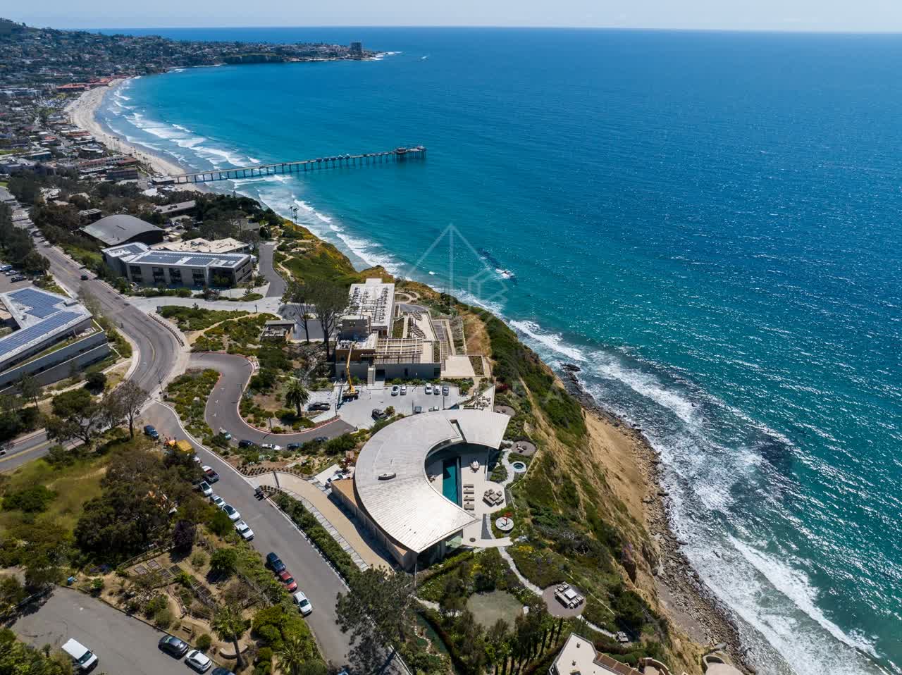 Aerial view of the cliffs, the surf and the pier at Black’s Beach.