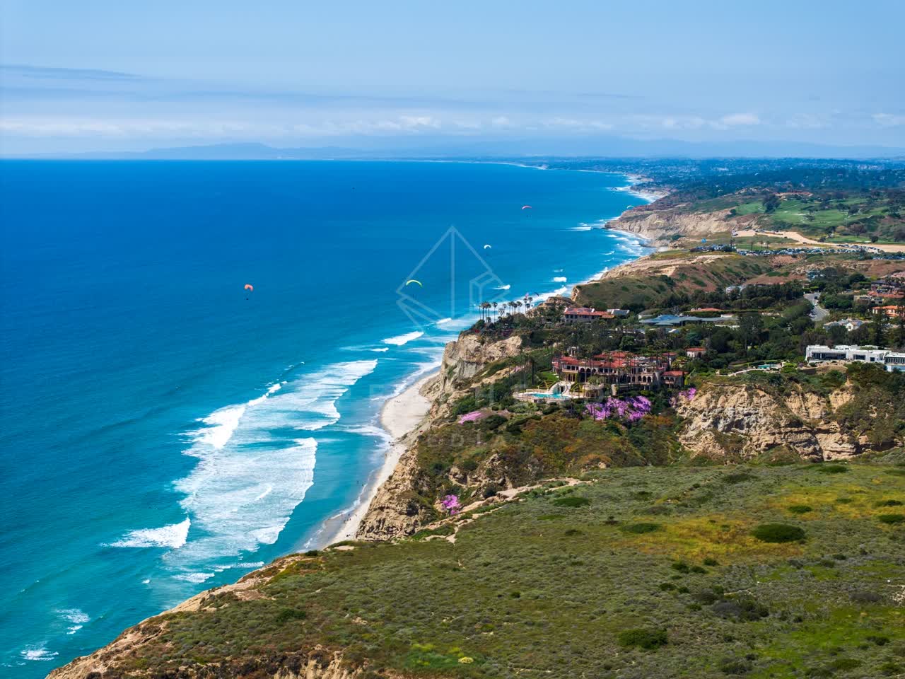 Aerial view of the cliffs, the surf and the ocean at Black’s Beach.