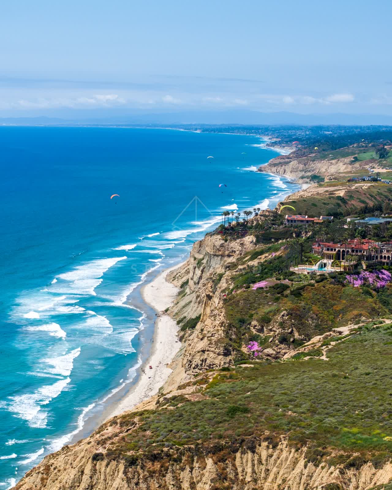 Aerial view of the cliffs, the surf and the ocean at Black’s Beach.