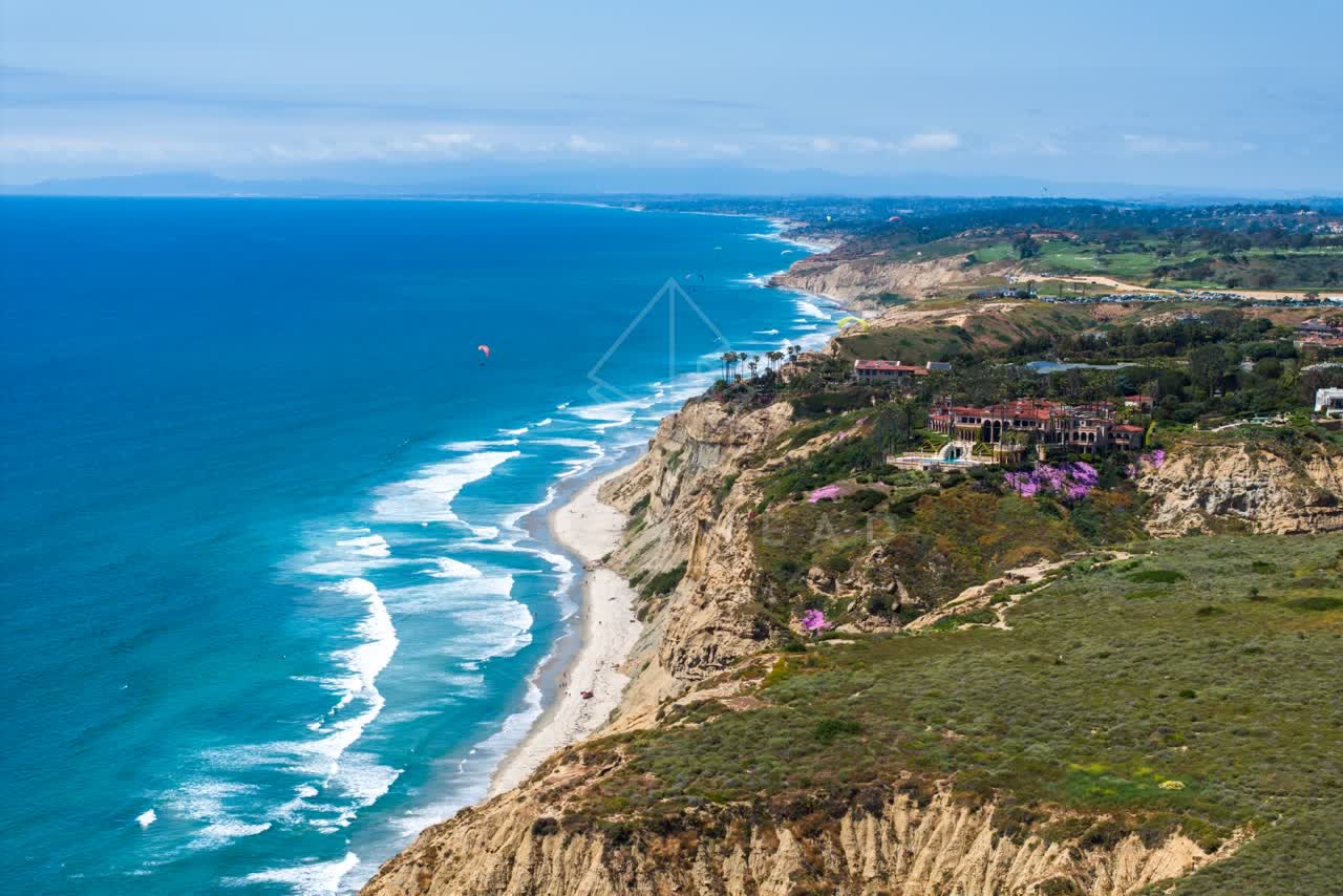 Aerial view of the cliffs, the surf and the ocean at Black’s Beach.
