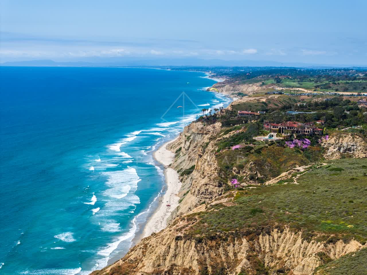 Aerial view of the cliffs, the surf and the ocean at Black’s Beach.