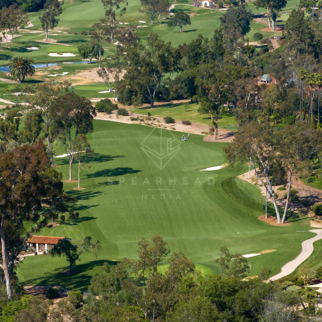 Aerial view of the country inland, palm trees and open country at Covenant, with people walking.