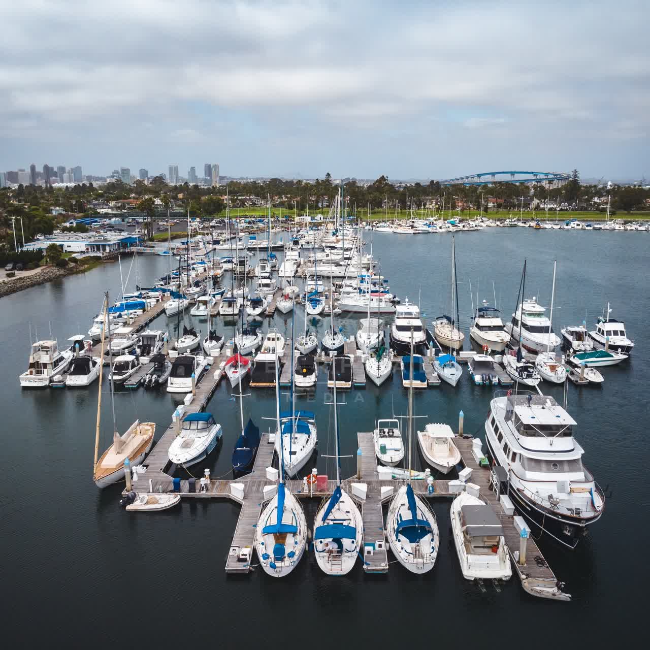 Aerial view of the harbor, the bridge and the skyline at Coronado Beach, with boats out.