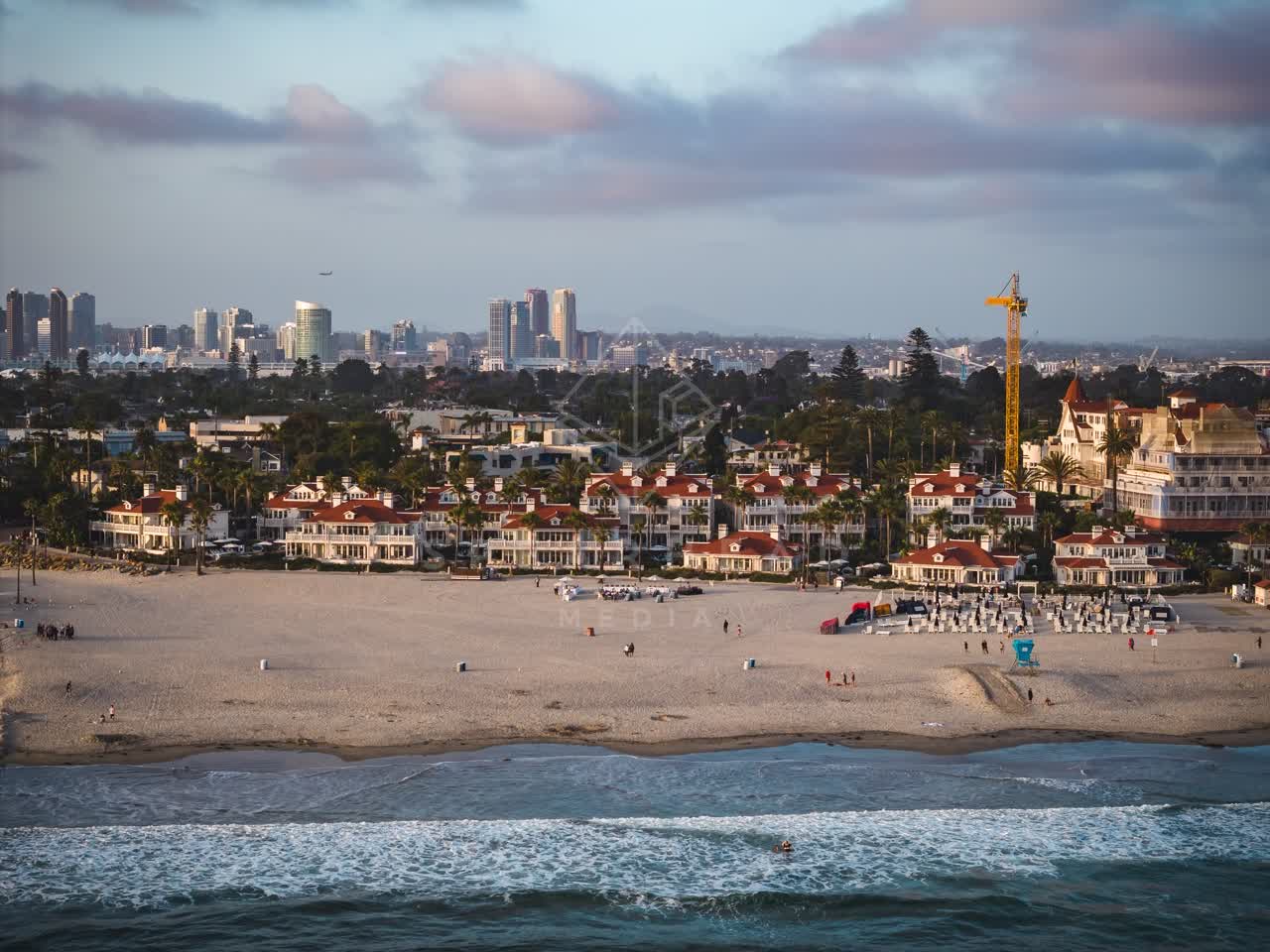 Aerial view of the beach, the skyline and palm trees at Coronado Beach.