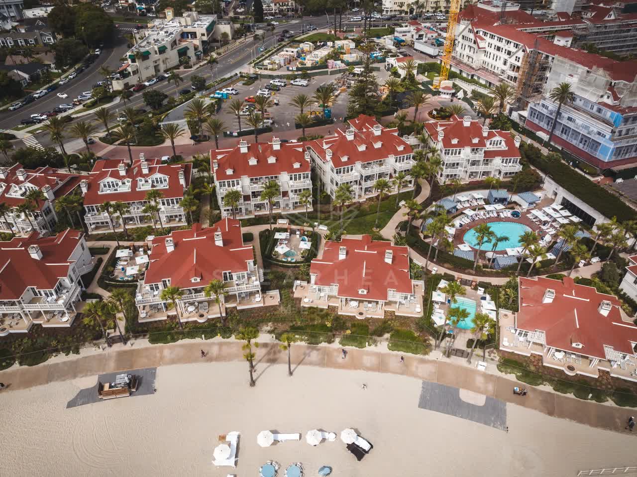 Aerial view of the beach, palm trees and the ocean at Coronado Beach.