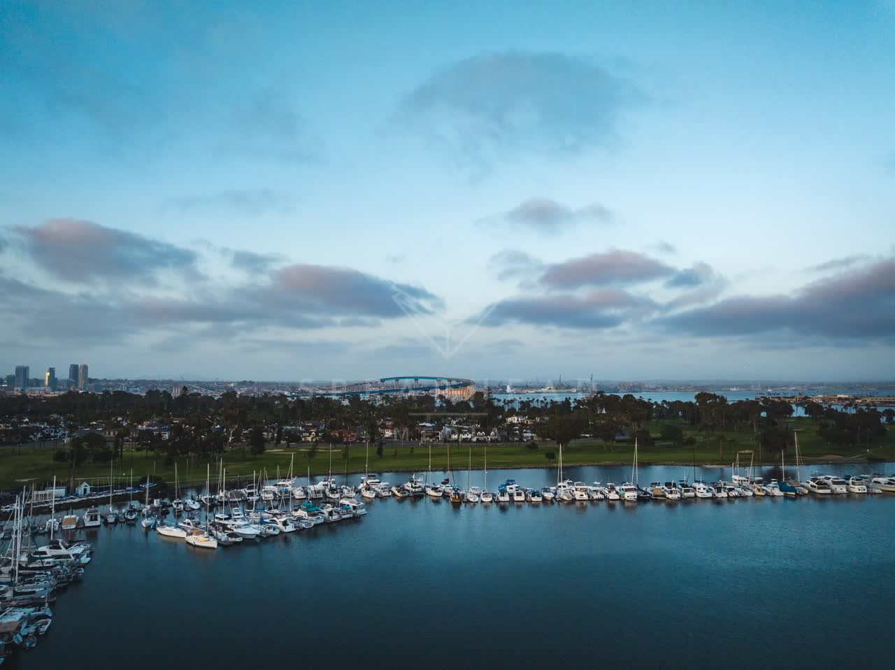 Aerial view of the harbor, the bridge and the skyline at Coronado Beach, with boats out.