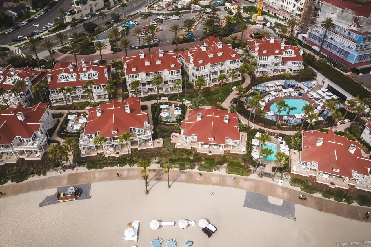 Aerial view of the beach, palm trees and the ocean at Coronado Beach.