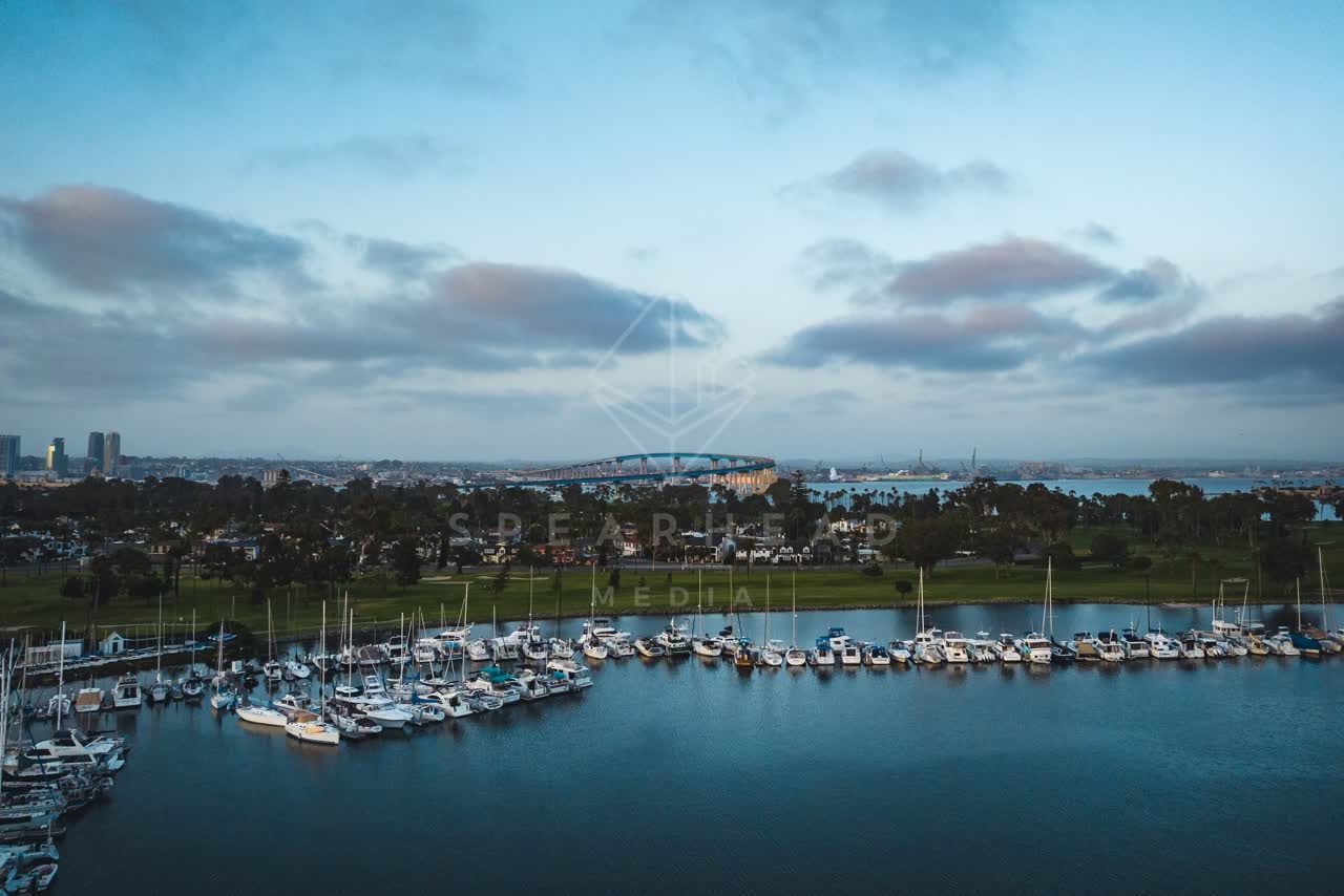 Aerial view of the harbor, the bridge and the skyline at Coronado Beach, with boats out.