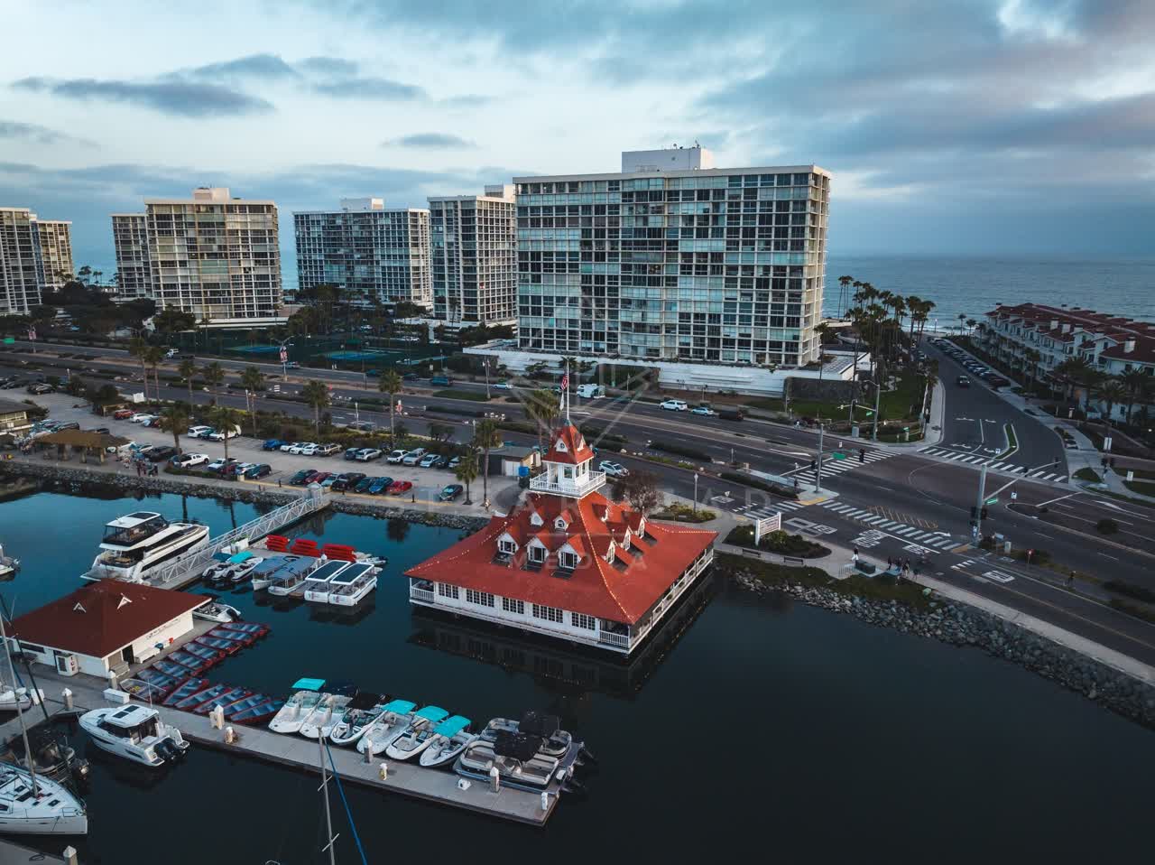 Aerial view of the harbor, the pier and boats at Coronado Beach, with boats out.