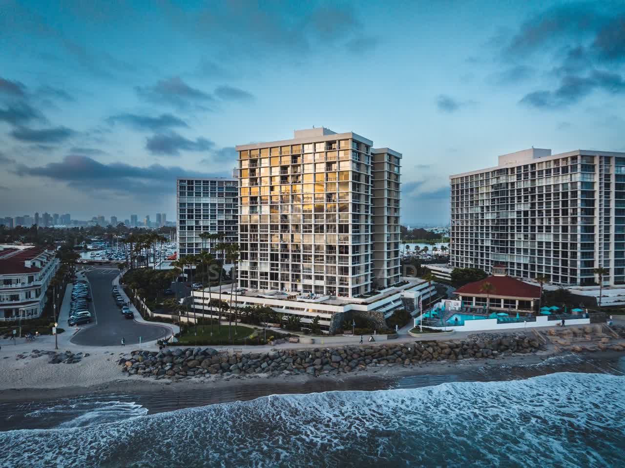 Aerial view of the beach, the surf and the skyline at Coronado Beach.