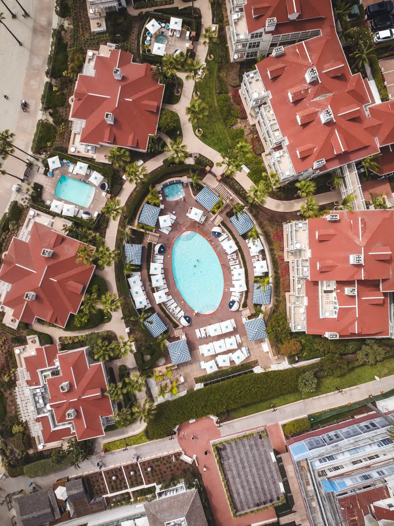 Aerial view of the beach, palm trees and the buildings at Coronado Beach.