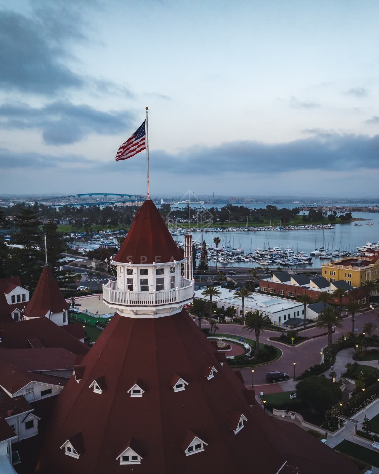 Low aerial view of the harbor, the bridge and boats at Coronado Beach.
