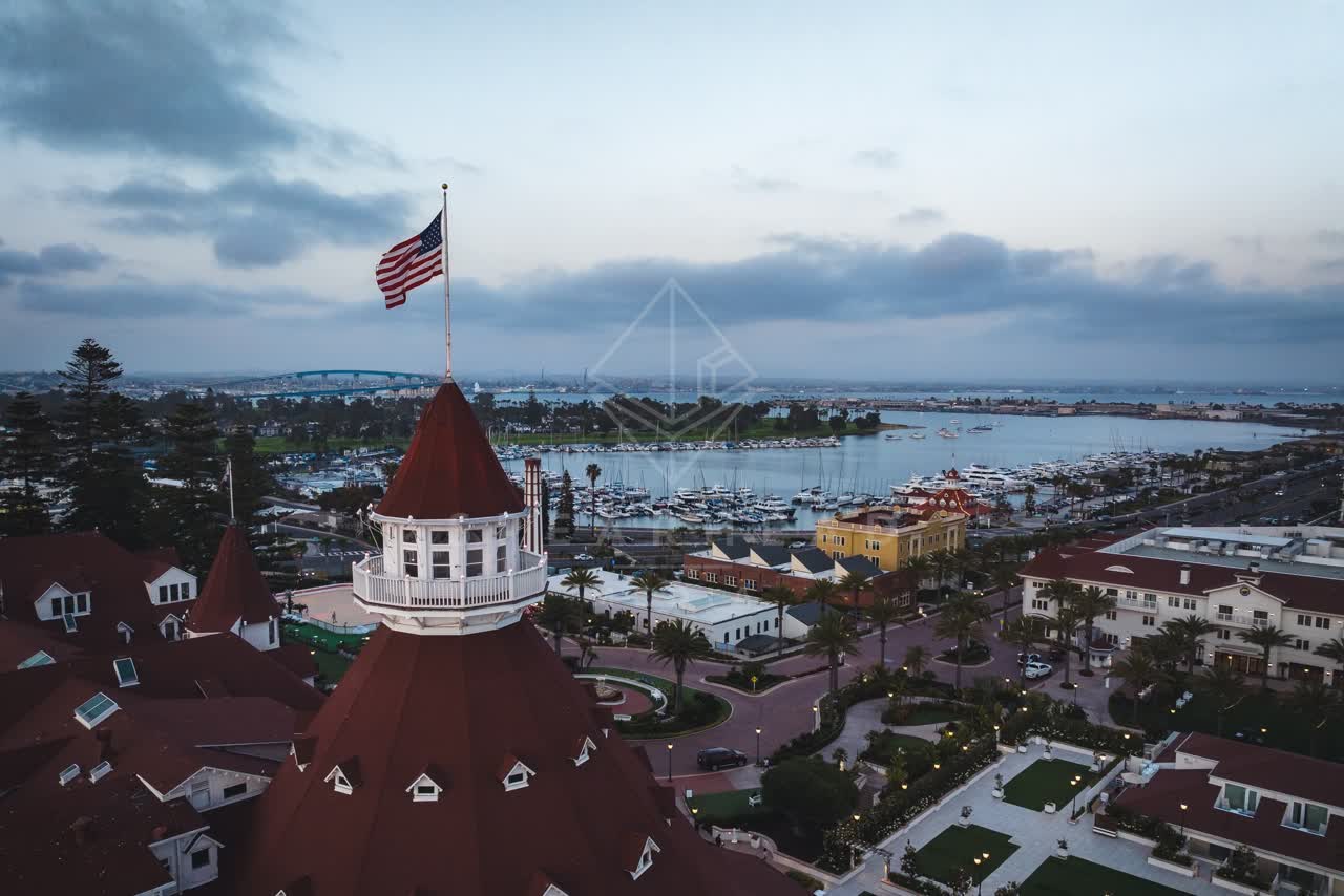 Low aerial view of the harbor, the bridge and boats at Coronado Beach.