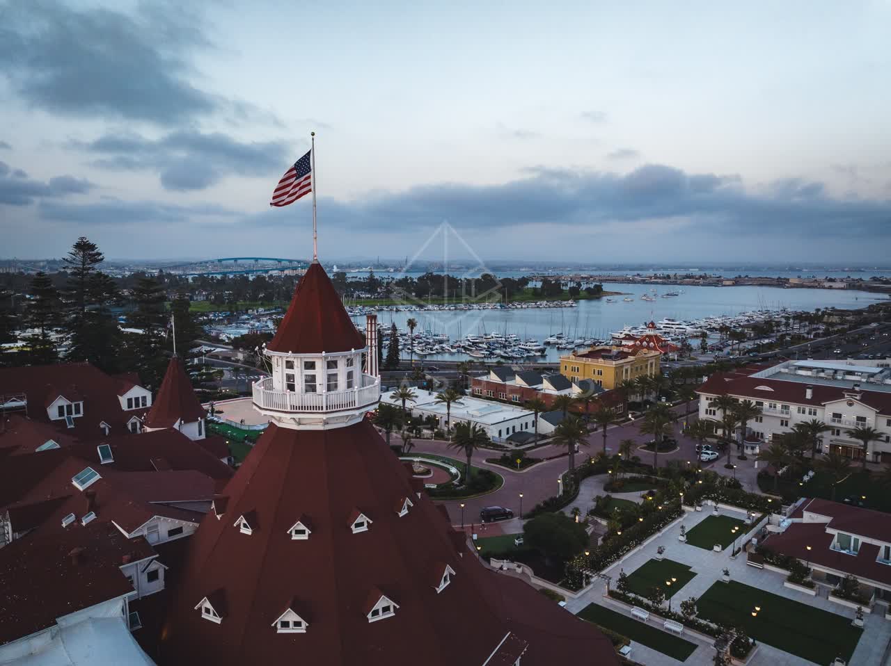 Low aerial view of the harbor, the bridge and boats at Coronado Beach.