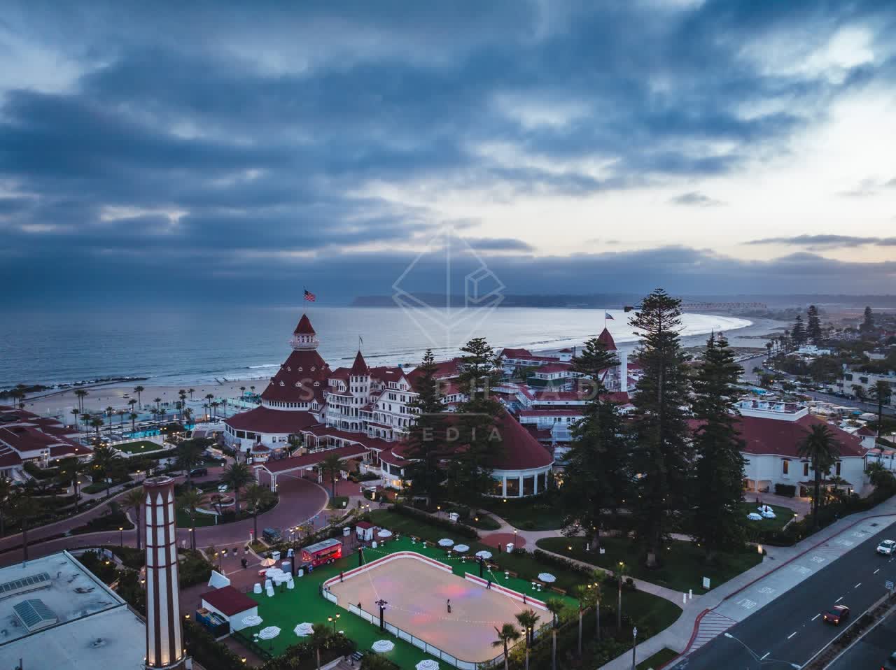 Aerial view of the beach, palm trees and the ocean at Coronado Beach.
