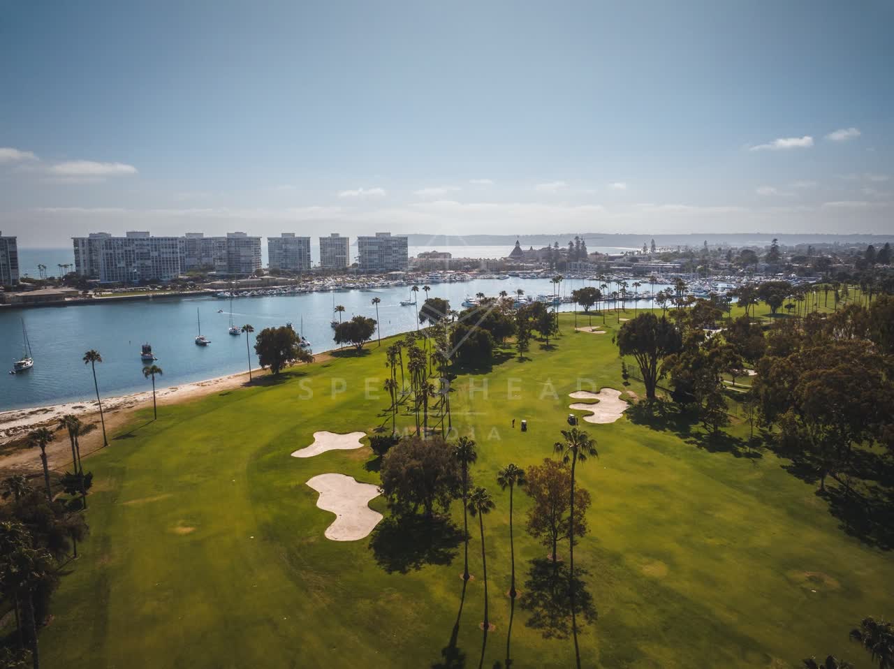 Aerial view of a park, boats and palm trees at Coronado Beach.