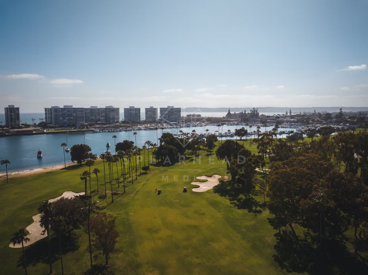 Aerial view of the harbor, boats and palm trees at Coronado Beach.