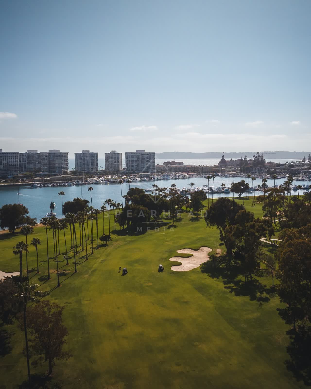 Aerial view of a park, boats and palm trees at Coronado Beach.