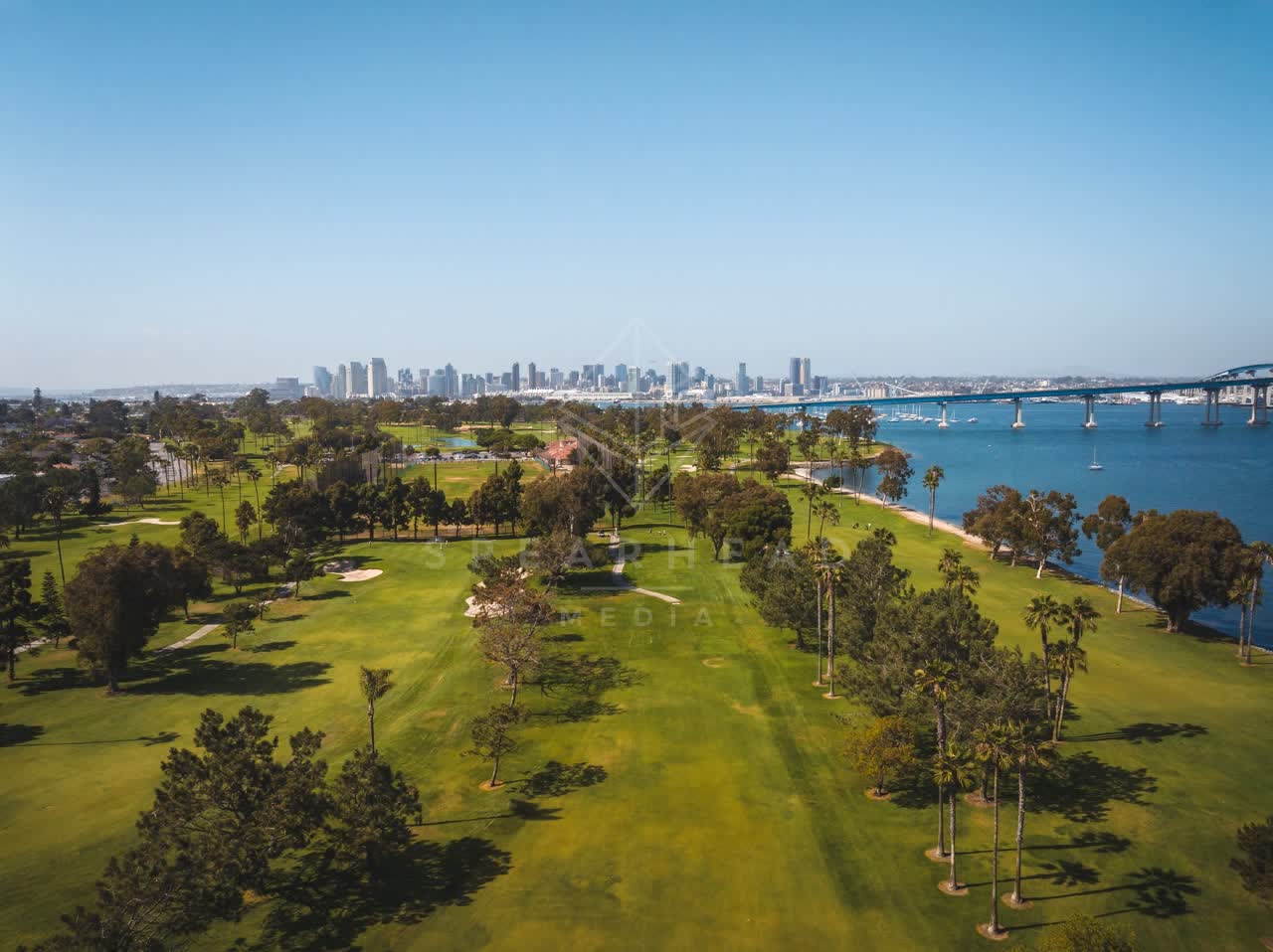 Aerial view of a park, the bridge and the skyline at Coronado Beach.