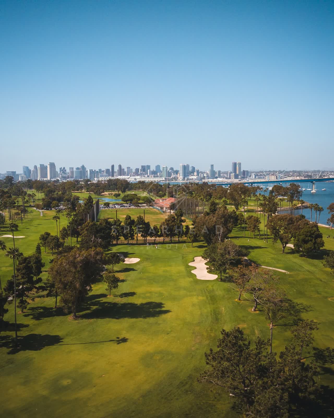 Aerial view of a park, the bridge and the skyline at Coronado Beach.