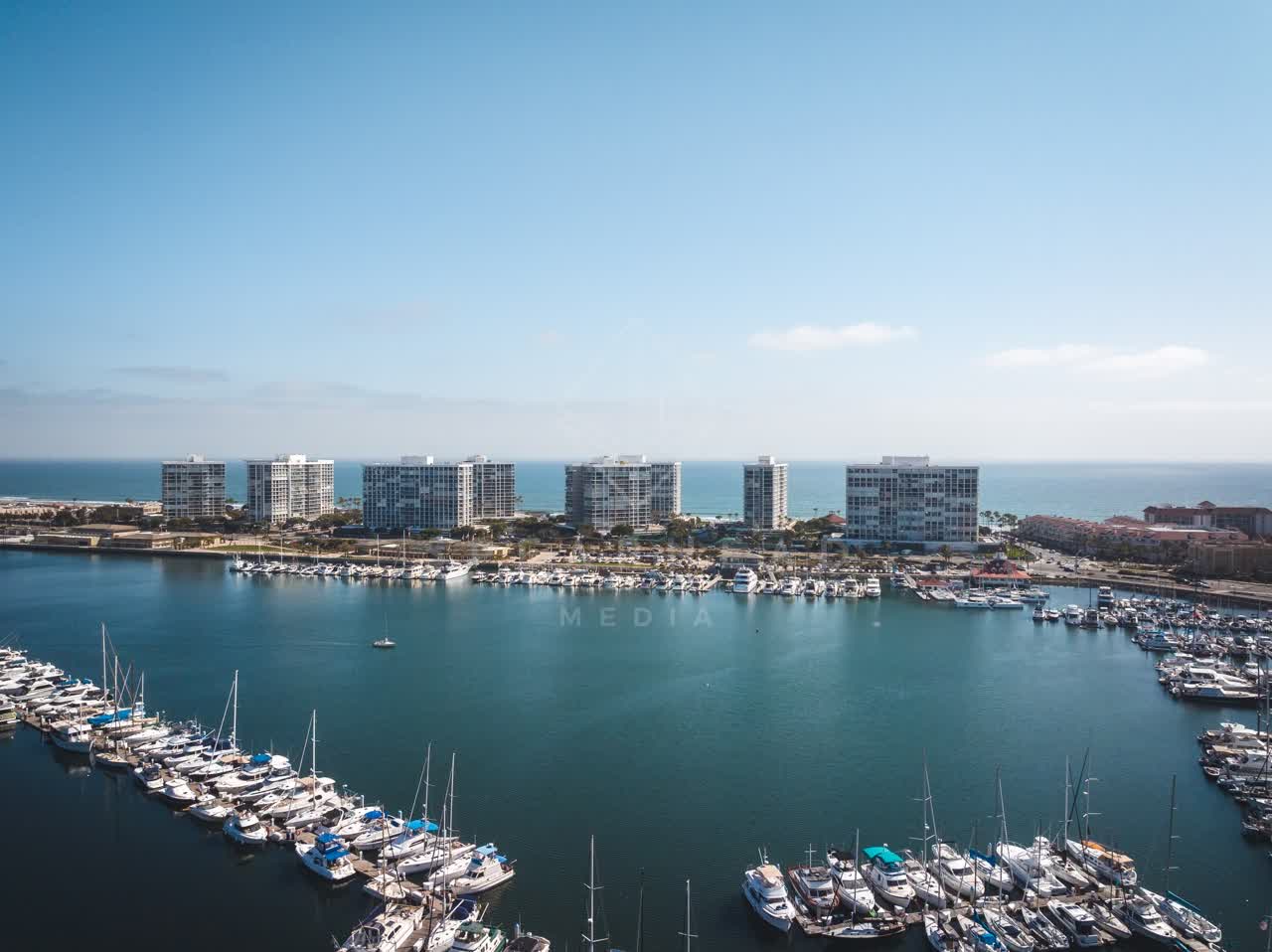 Aerial view of the harbor, boats and the ocean at Coronado Beach, with boats out.