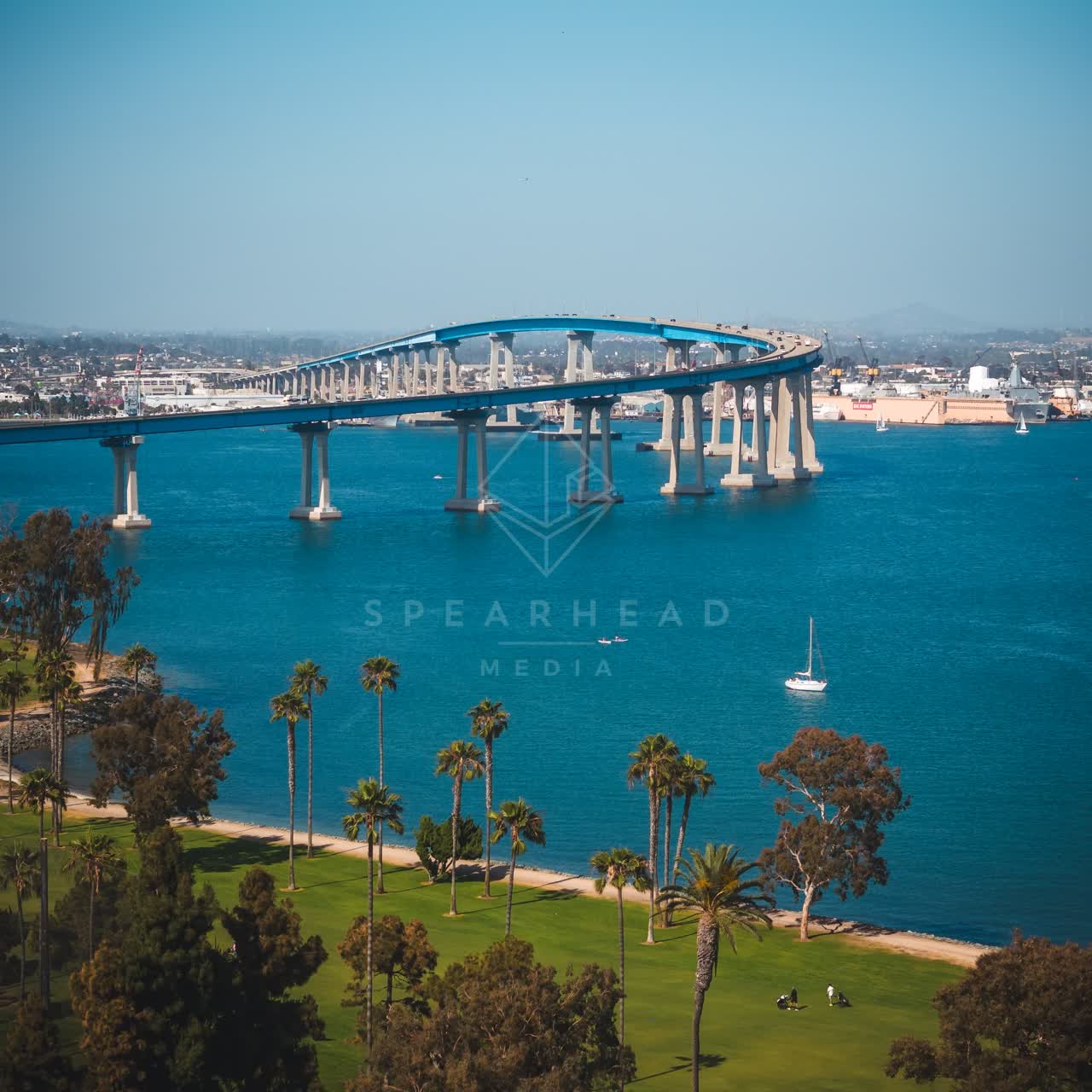 Aerial view of the harbor, the bridge and boats at Coronado Beach, with boats out.