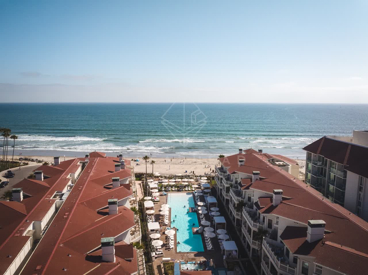 Aerial view of the beach, the surf and the pier at Coronado Beach.