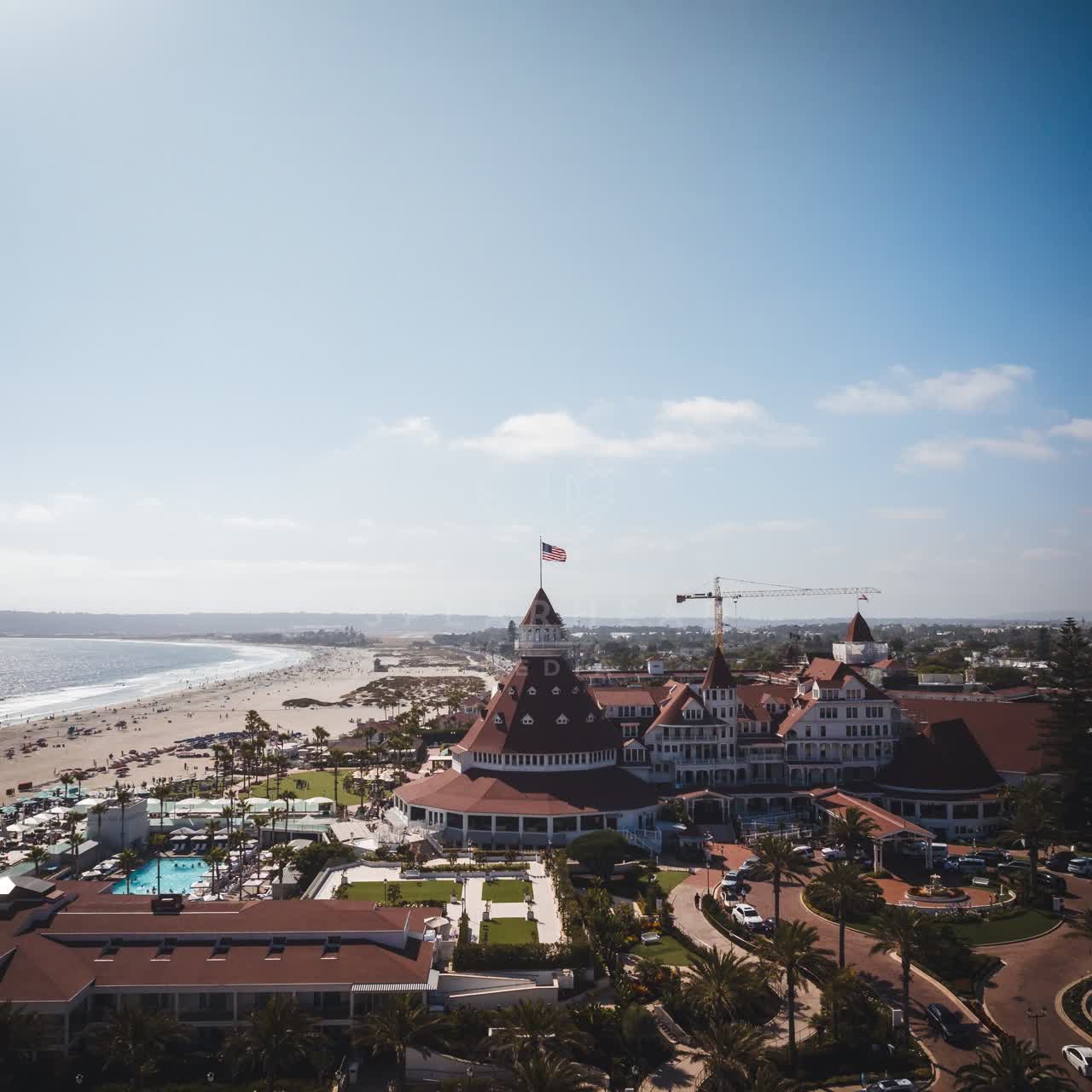 Aerial view of the beach, palm trees and the ocean at Coronado Beach.