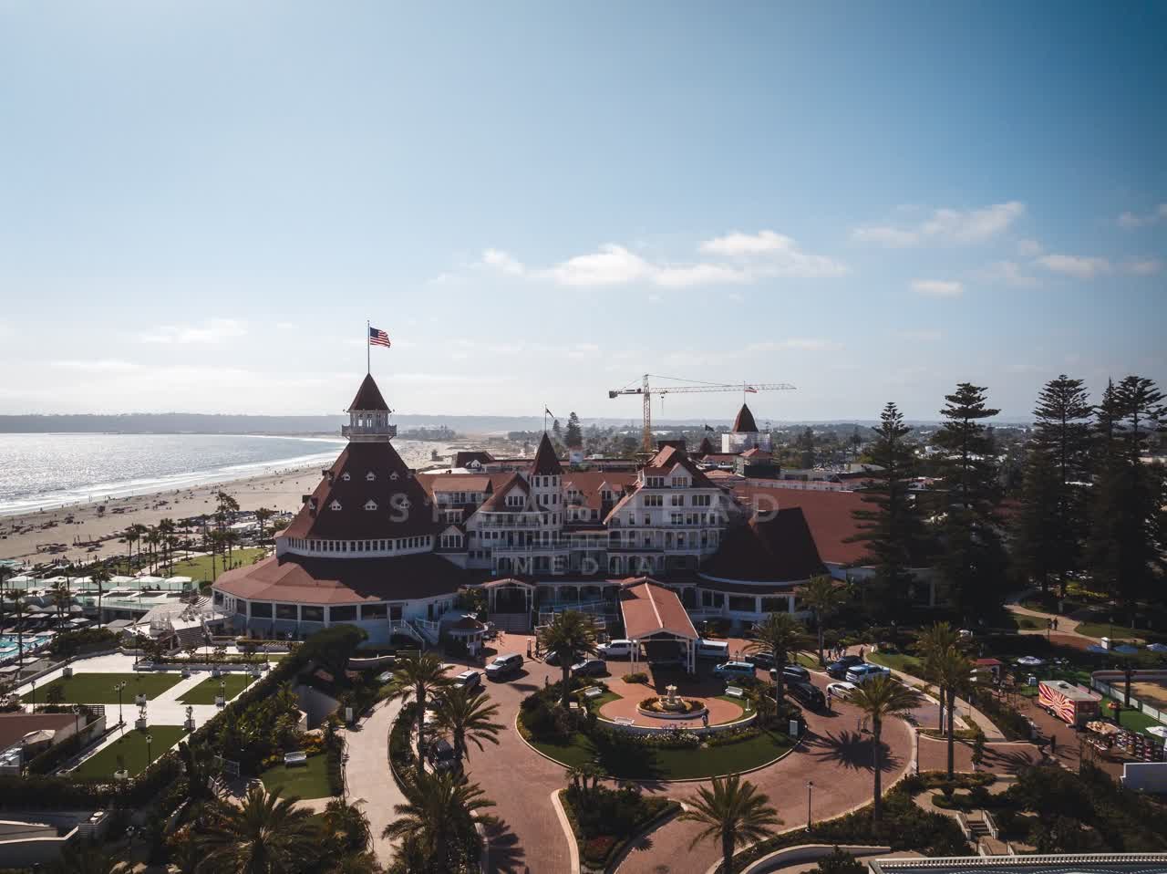 Aerial view of the beach, palm trees and the ocean at Coronado Beach.