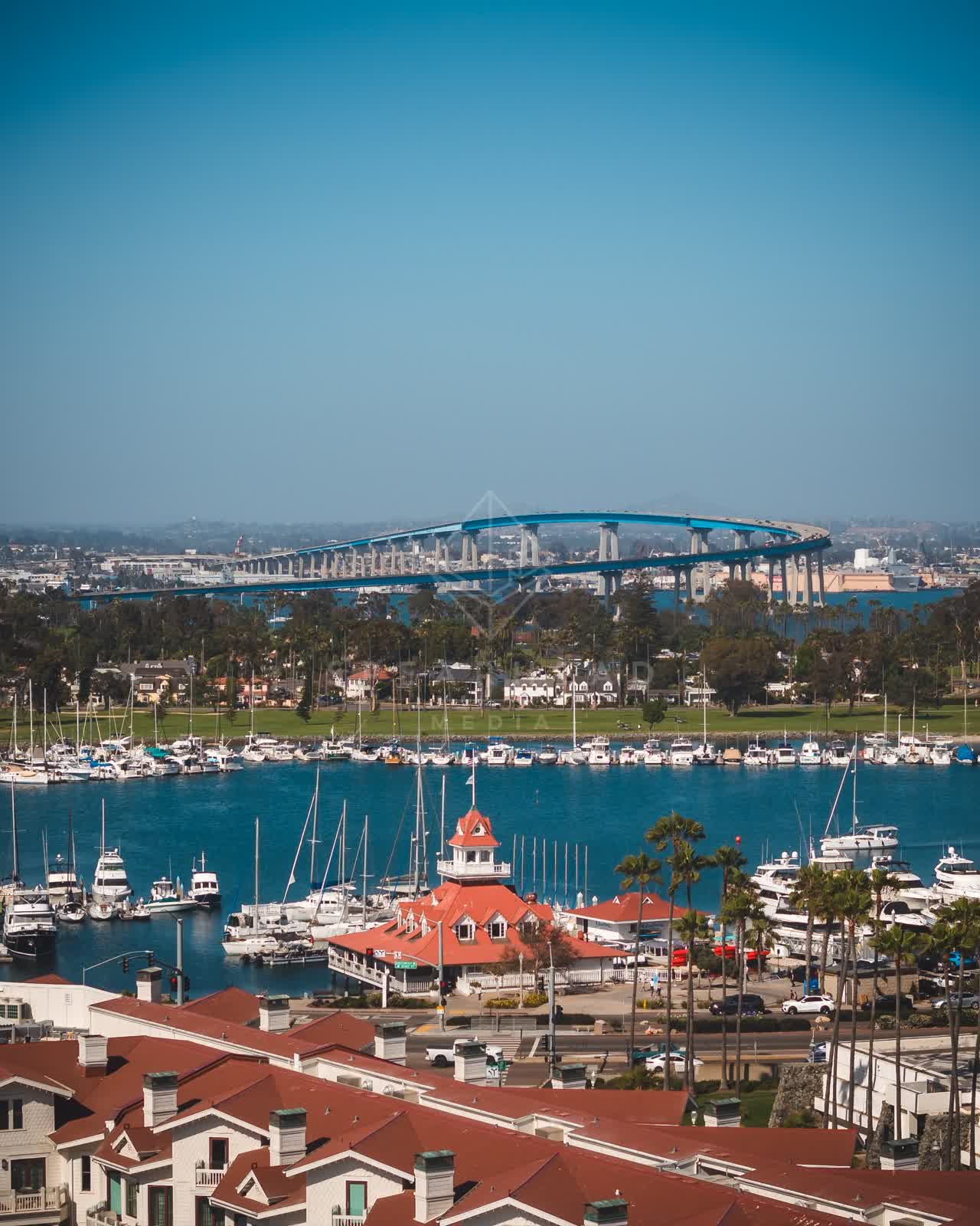 Elevated view of the harbor, the bridge and boats at Coronado Beach, with boats out.