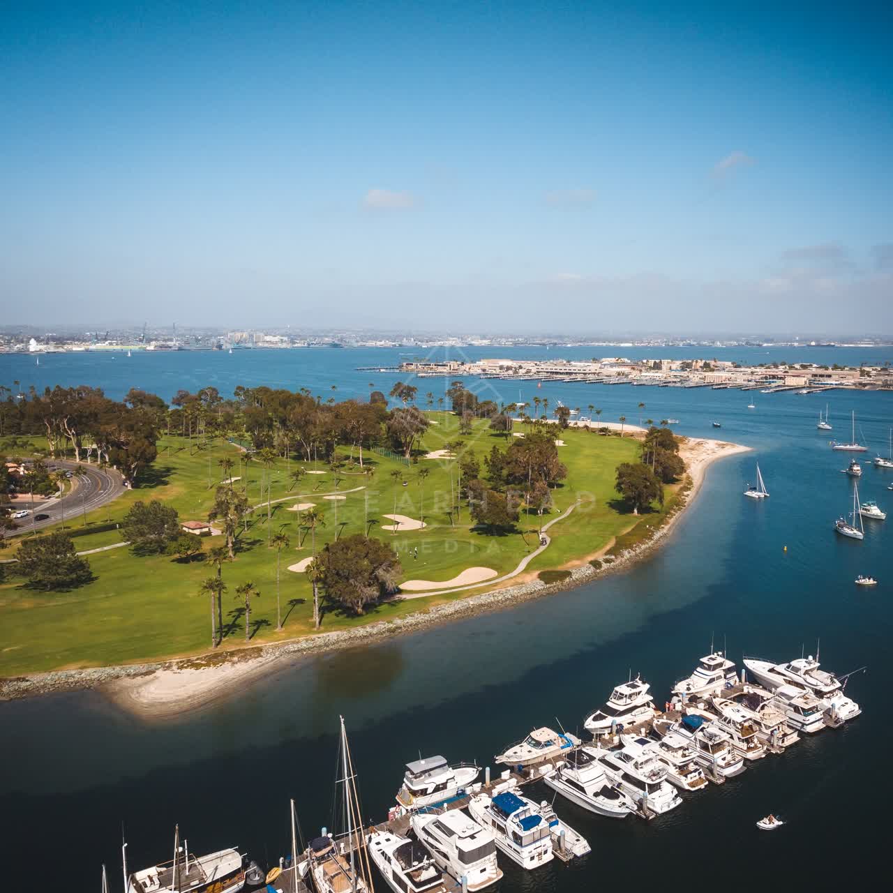 Aerial view of the harbor, boats and palm trees at Coronado Beach, with boats out.