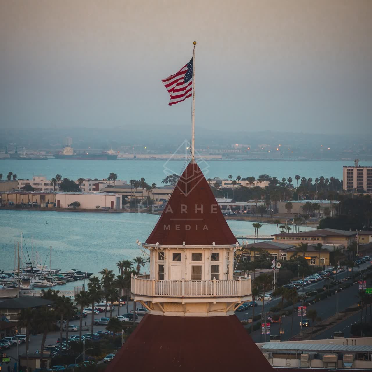 Low aerial view of the harbor, boats and palm trees at Coronado Beach.