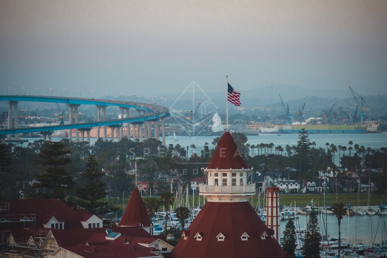Low aerial view of the harbor, the bridge and boats at Coronado Beach.