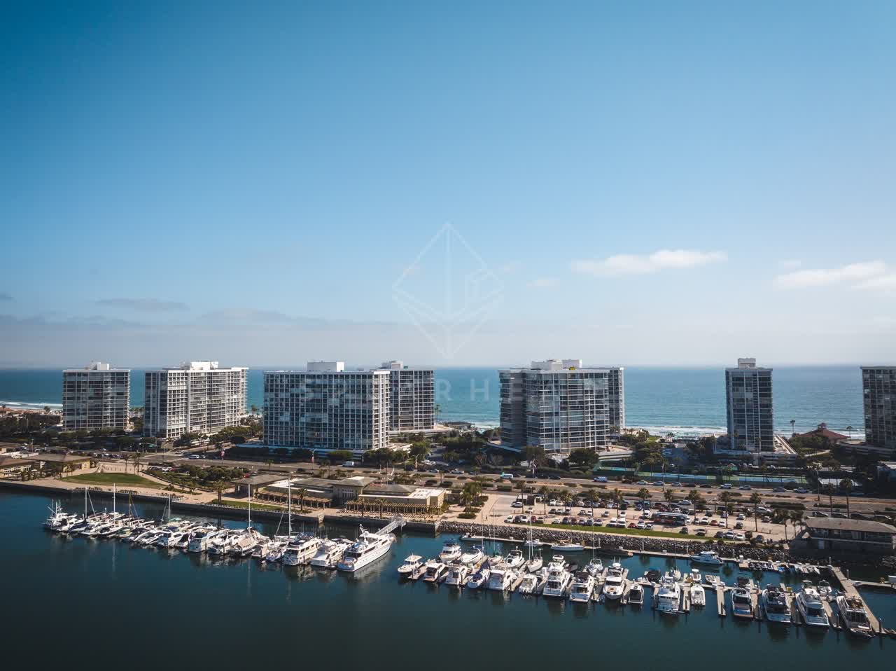 Aerial view of the harbor, boats and the ocean at Coronado Beach, with boats out.