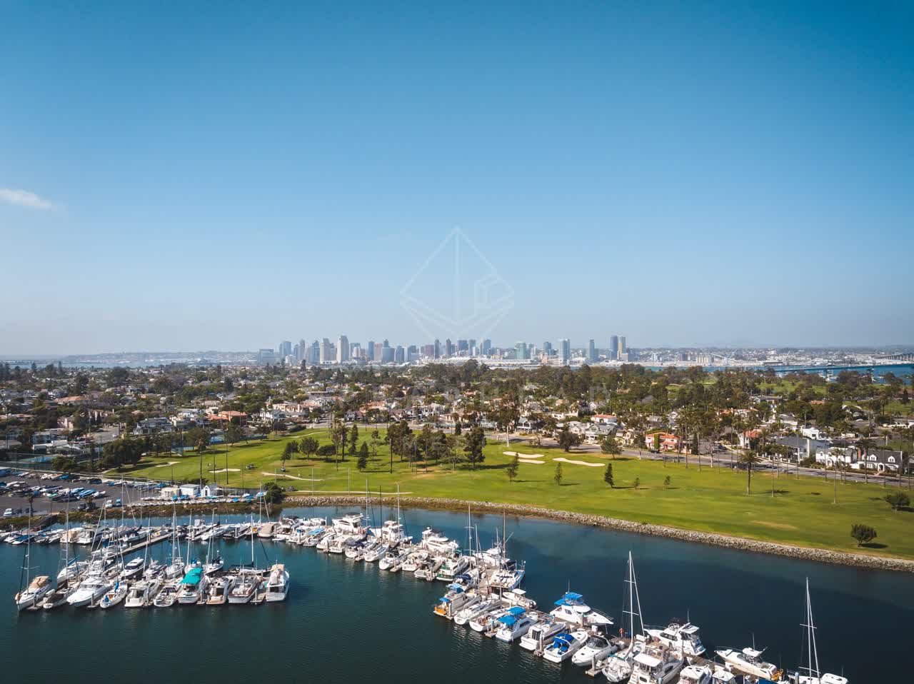 Aerial view of the harbor, the skyline and boats at Coronado Beach, with boats out.