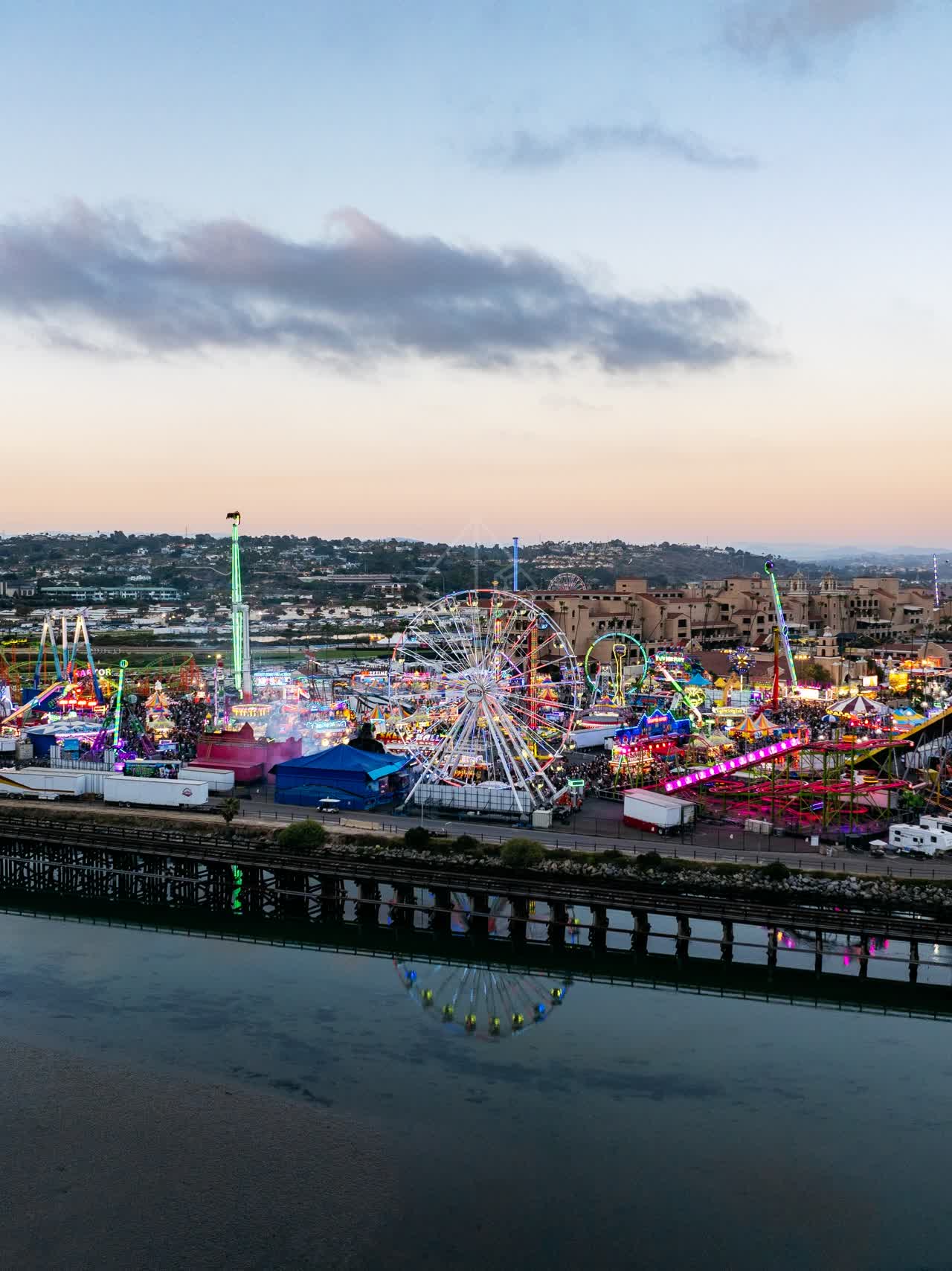 Aerial view of the country inland, traffic and open country in Del Mar, with a crowd gathered.