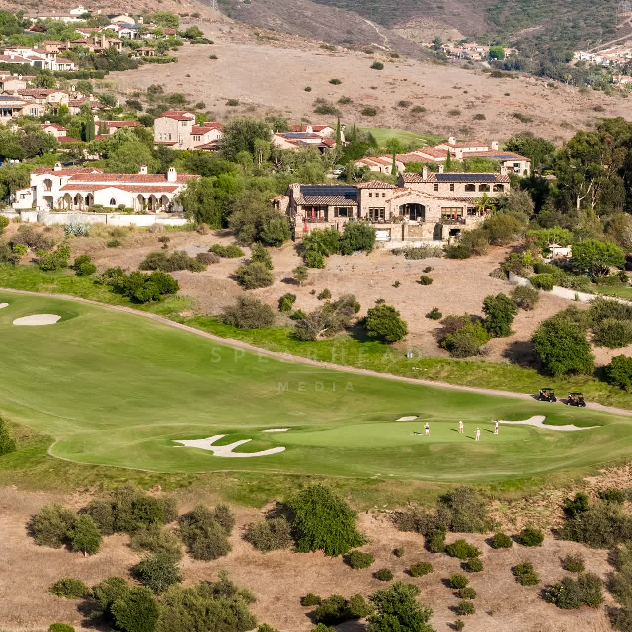 Aerial view of the country inland, homes and the buildings in Santaluz, with people walking.